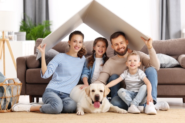 Happy family with dog enjoying new home